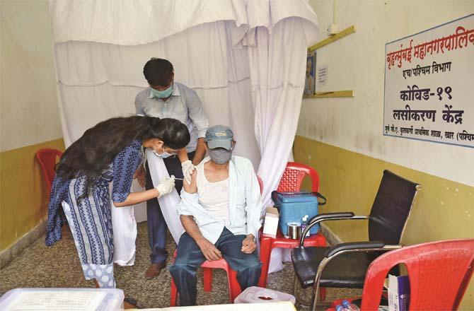 A man is being vaccinated at GA Kalkarni School in Khar West.Picture:Inquilb